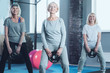© Viacheslav Yakobchuk - It is never too late. Motivated elderly ladies enjoying their training while lifting weight disks during a training class in a fitness club.
