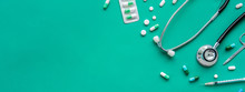 Pills And Medical Equiupments On Green Banner Background