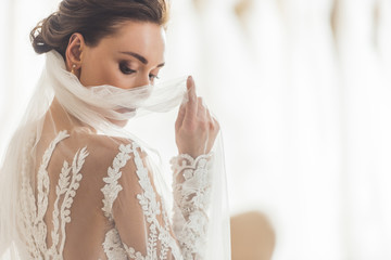 stylish bride in lace dress in wedding salon