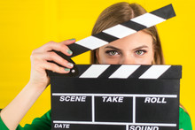Attractive Woman With A Clapperboard In Her Arms