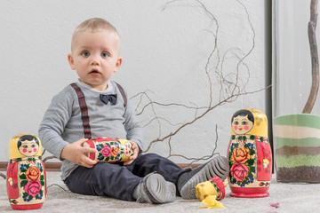 The little boy plays with Russian nested doll