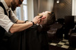 © innervisionpro - Barber shaving client neck with razor