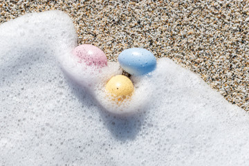 Colorful Easter eggs on the seaside in sunny day. Easter concept.