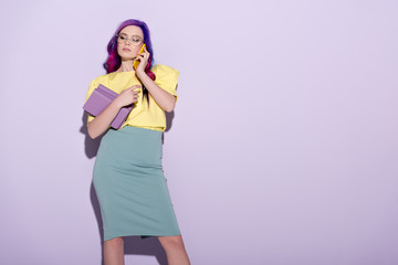 Wall Mural - beautiful young woman with colorful hair holding books and talking by phone on pink