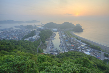 Wall Mural - Aerial view of Nanfangao harbor at dawn, a fishing village on northeastern coast of Taipei Taiwan ~ Scenery of misty sunrise reflecting on peaceful sea water by beautiful coastline