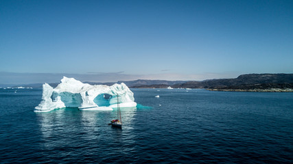 Wall Mural - yacht and amazing iceberg. greenland view from drone.