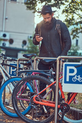 Wall Mural - A handsome hipster traveler with a stylish beard and tattoo on h