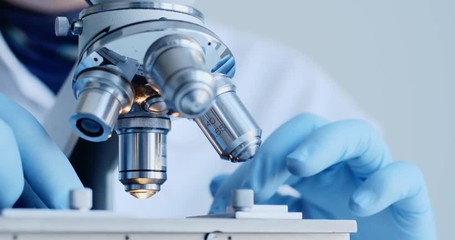 scientist hands with microscope close-up shot in the laboratory