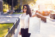 © Novak - Young woman with shopping bag at street