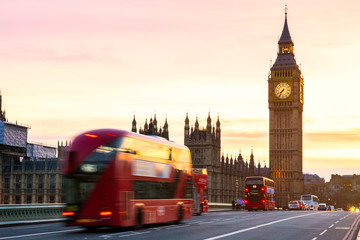 London, the UK. Red bus in motion and Big Ben, the Palace of Westminster. The icons of England