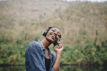 Wall Mural - Woman listening to music in nature