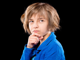 emotional portrait of thoughtful beautiful little girl holding her head to imagine or think. funny c