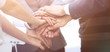 © ASDF - business colleagues with their hands stacked together