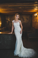 woman in wedding dress posing in luxury interior