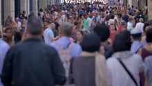 Crowd Walking In A Large Street. Slow Motion Footage Of Anonymous People Walking