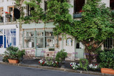 Fototapeta Most - Cozy street with tables of cafe in Paris, France