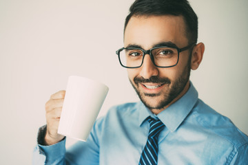 Wall Mural - Closeup of Content Handsome Man Having Tea