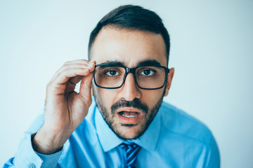 Wall Mural - Surprised Business Man Staring Through Glasses