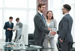 © ASDF - handshake business partners at a meeting