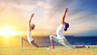 © Syda Productions - fitness and people concept - couple making yoga low lunge pose outdoors over sea background