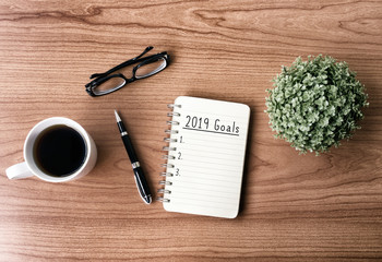 Wall Mural - New year goals and resolution concept - 2019 goals text on notepad. Retro style background.