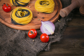 Wall Mural - Cherry tomatoes, uncooked spaghetti, red onion and herbs