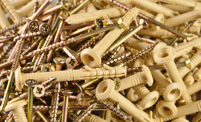 Wall Mural - Background with dowel nails. Group of nail-plugs with plastic nails close up.