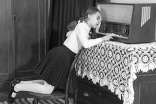 Little Girl Listens To Old Radio.