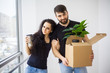 © Maksymiv Iurii - Couple showing keys to new home hugging looking at camera