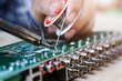 © poylock19 - Technician desolder remove part component on board electronic for repair.