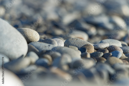 Fotografie, Obraz Piles of grey rocks in the sand on the beach