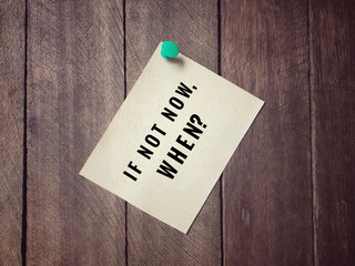 Motivational and inspirational quotes - ‘If not now, when?’ on white paper. With vintage styled background.