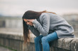 Young lonely and depressed woman is sitting in grief. 