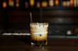 © jamurka - A horizontal image of a white russian cocktail in rocks glass in a bar.