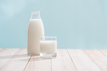 Dairy Products. Bottle With Milk And Glass Of Milk On Wooden Table