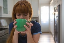 Woman Having Coffee In Green Mug