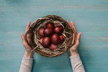 Cropped Image Of Woman Holding Easter Basket With Painted Eggs