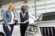 Sales Consultant Shows The Girl A New Car To Buy