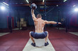 © satyrenko - Cross fit training. Fitness man doing a weight training by lifting kettlebell. Young athlete doing kettlebell swings. Bodybuilder lifting kettlebell. Cross fit instructor at the gym. Cross fit in the
