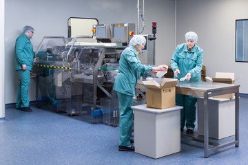 Canvas Print - Pharmaceutical factory workers in sterile environment