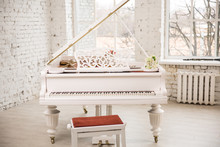 White Grand Piano Standing In Elegant White Interior