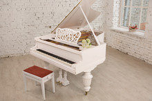 White Grand Piano Standing In Elegant White Interior