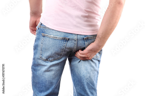 Fotografie, Obraz Man in jeans scratching hand his itchy ass