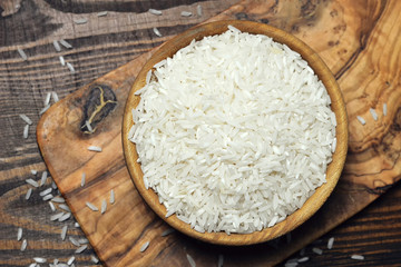 Wall Mural - White rice in wooden bowl, top view