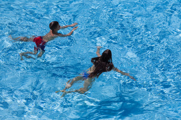 Wall Mural - Two kids swim in pool together