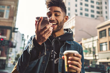 Portrait Of Stylish Young Man With Coffee And Smartphone On The Street