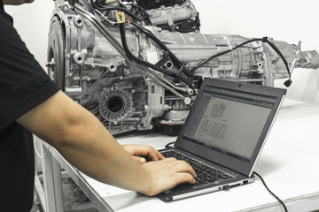 engineer working on computer at the design of mechanical piece