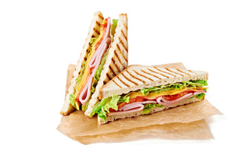 Wall Mural - Sandwich with ham, cheese, tomatoes, lettuce, and toasted bread. Above view isolated on white background.