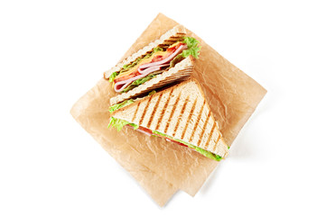 Wall Mural - Sandwich with ham, cheese, tomatoes, lettuce, and toasted bread. Above view isolated on white background.