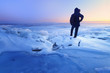 © ml1413 - the ice desert frozen lake / the man looks towards the dawn